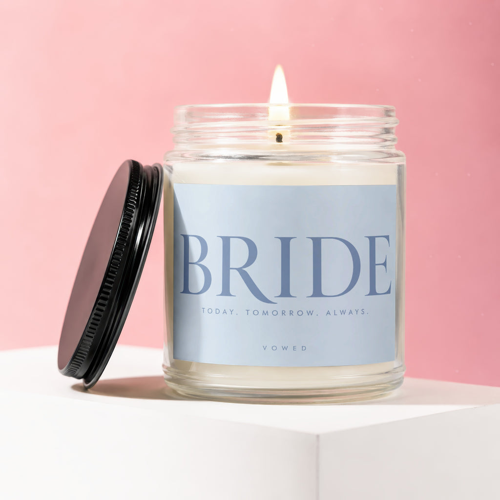 Candle with lit wick and lid off, labeled "BRIDE TODAY. TOMORROW. ALWAYS. VOWED".