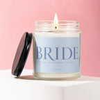 Candle with lit wick and lid off, labeled "BRIDE TODAY. TOMORROW. ALWAYS. VOWED".