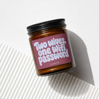 Amber glass candle with "Two wives, one wifi password" text on a rose label.
