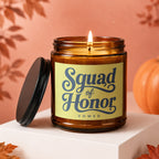 Amber candle with lid off, lit flame, label reads "Squad of Honor VOWED."