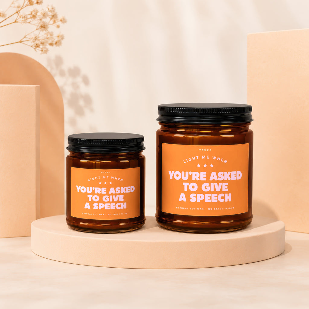 Two amber jar candles with black lids, labeled "You're Asked to Give a Speech".
