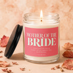 Candle with "Mother of the Bride" text, lid off, flame lit.