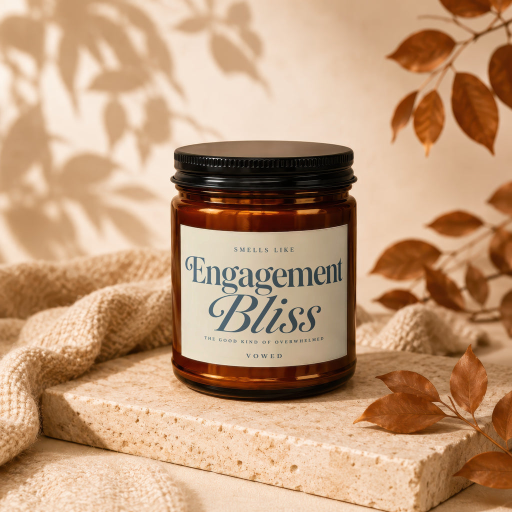 Amber jar candle labeled "Engagement Bliss" with rustic autumn decor.