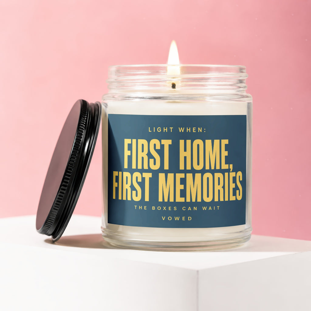 Glass candle with label "Light When: First Home, First Memories. The Boxes Can Wait."