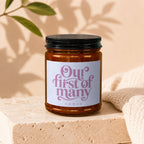 Amber jar candle with pink text "Our first of many" and "vowed".