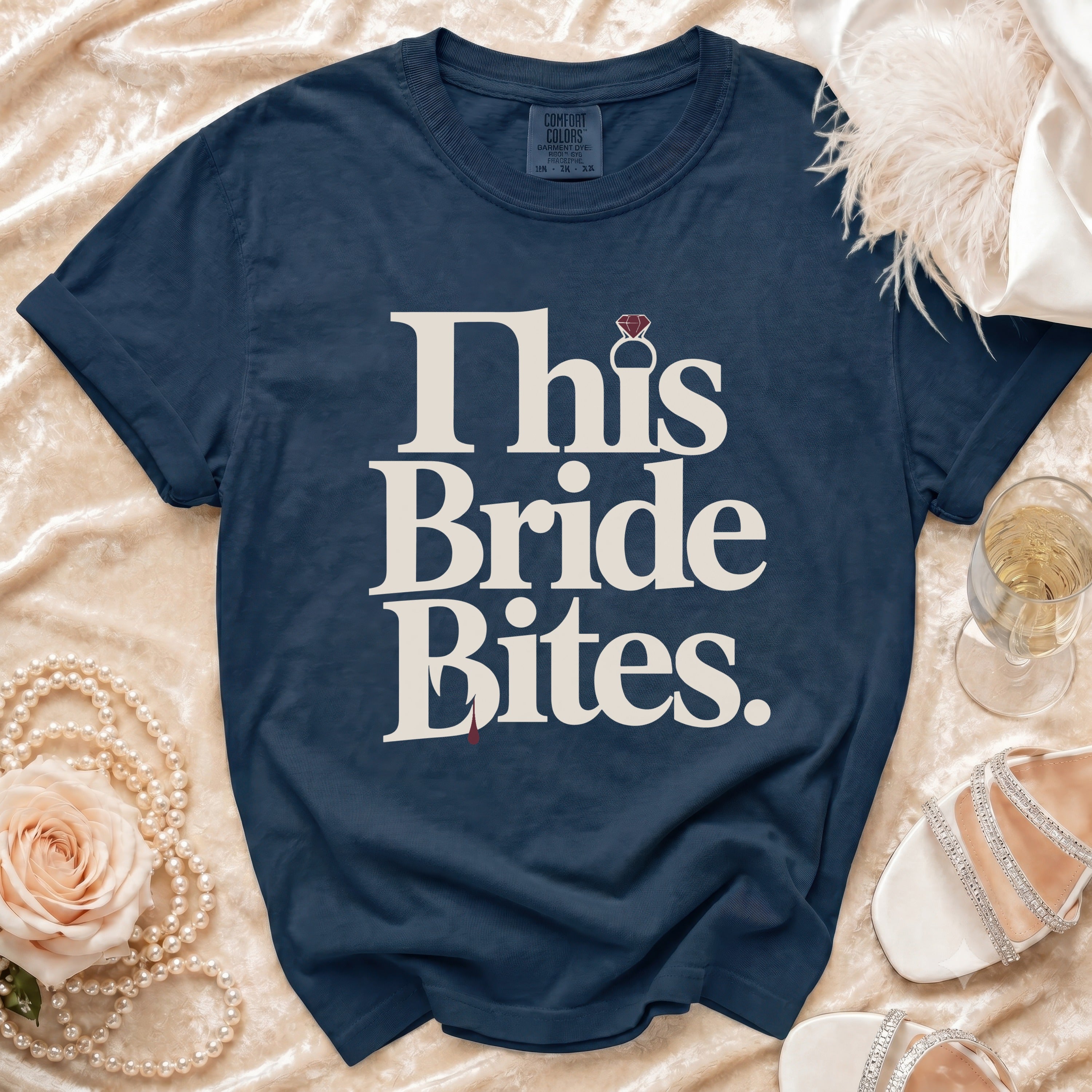Navy t-shirt with "This Bride Bites" graphic and diamond ring detail.