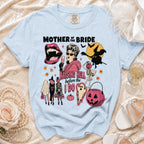 Light blue t-shirt with "Mother of the Bride Raising Hell Before the I Do" graphic.