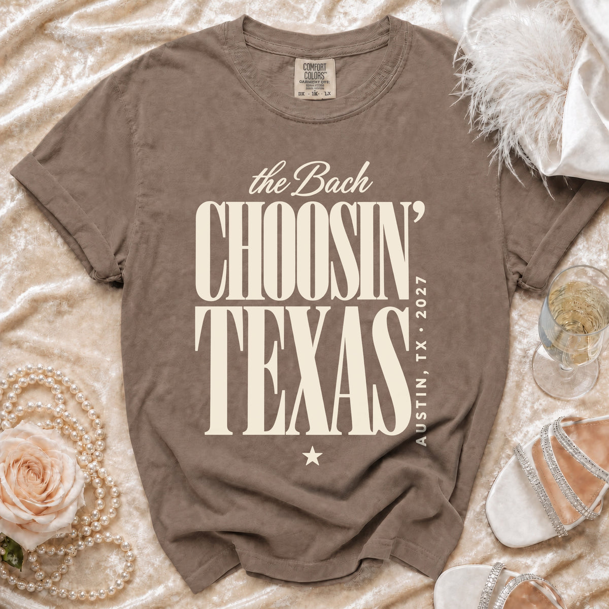 Brown t-shirt featuring cream text that reads The Bach Choosin Texas Austin TX 2027.