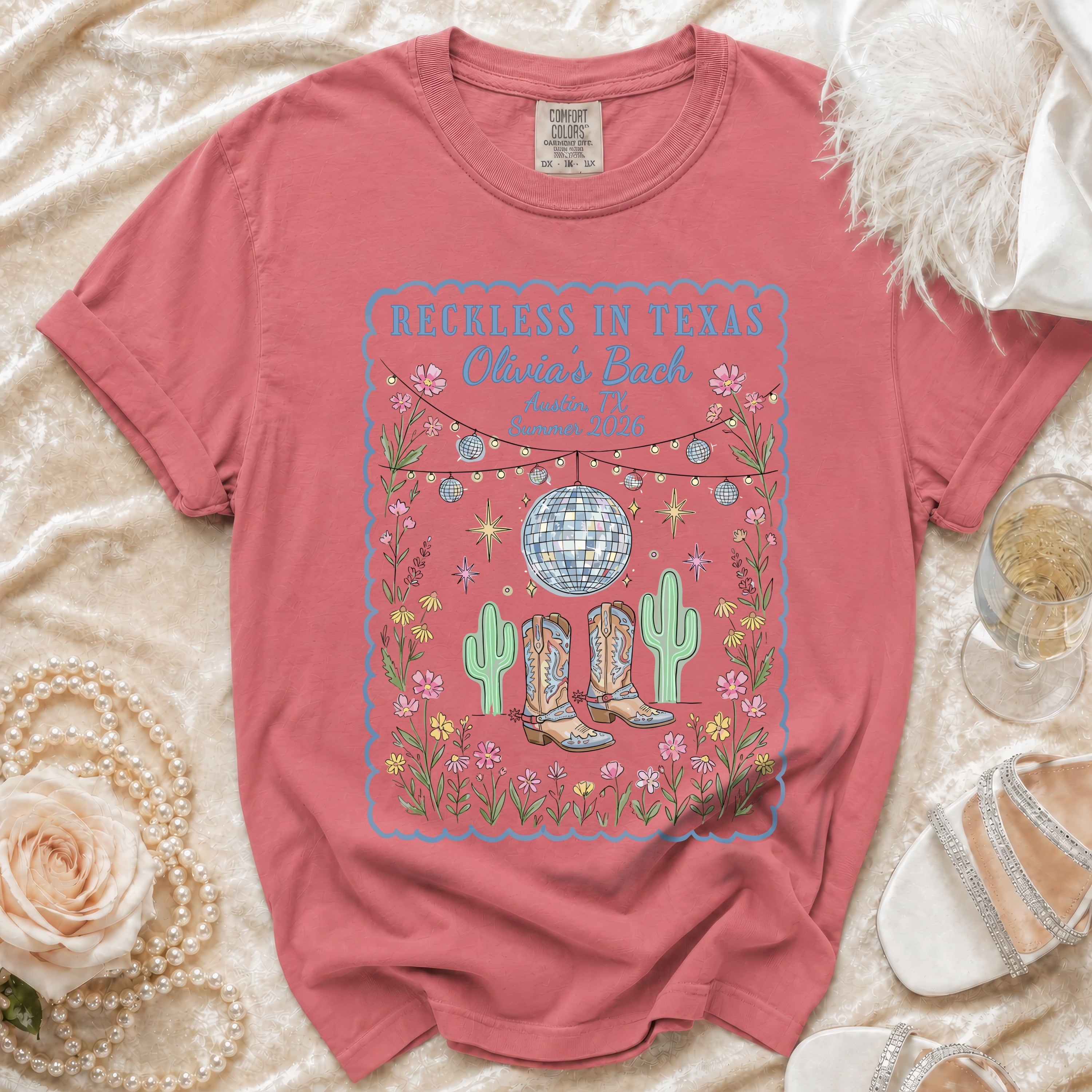 T-shirt with "Reckless in Texas Olivia's Bach" text, disco ball, and cowboy boots.