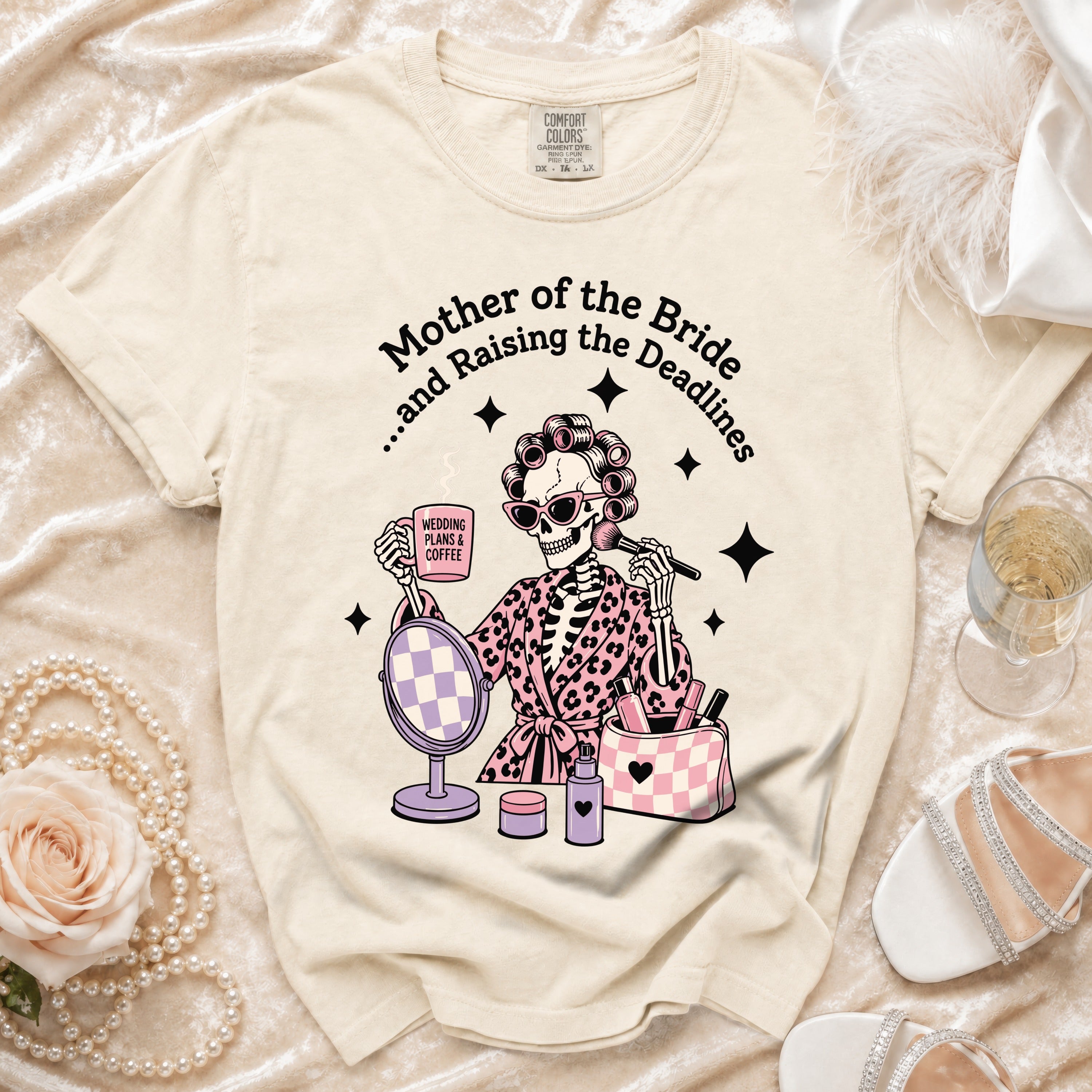 Skeleton graphic on a cream t-shirt reads "Mother of the Bride...and Raising the Deadlines".