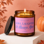 Amber jar candle with pink label reading "Smells Like Love, Laughter & Always After Vowed".