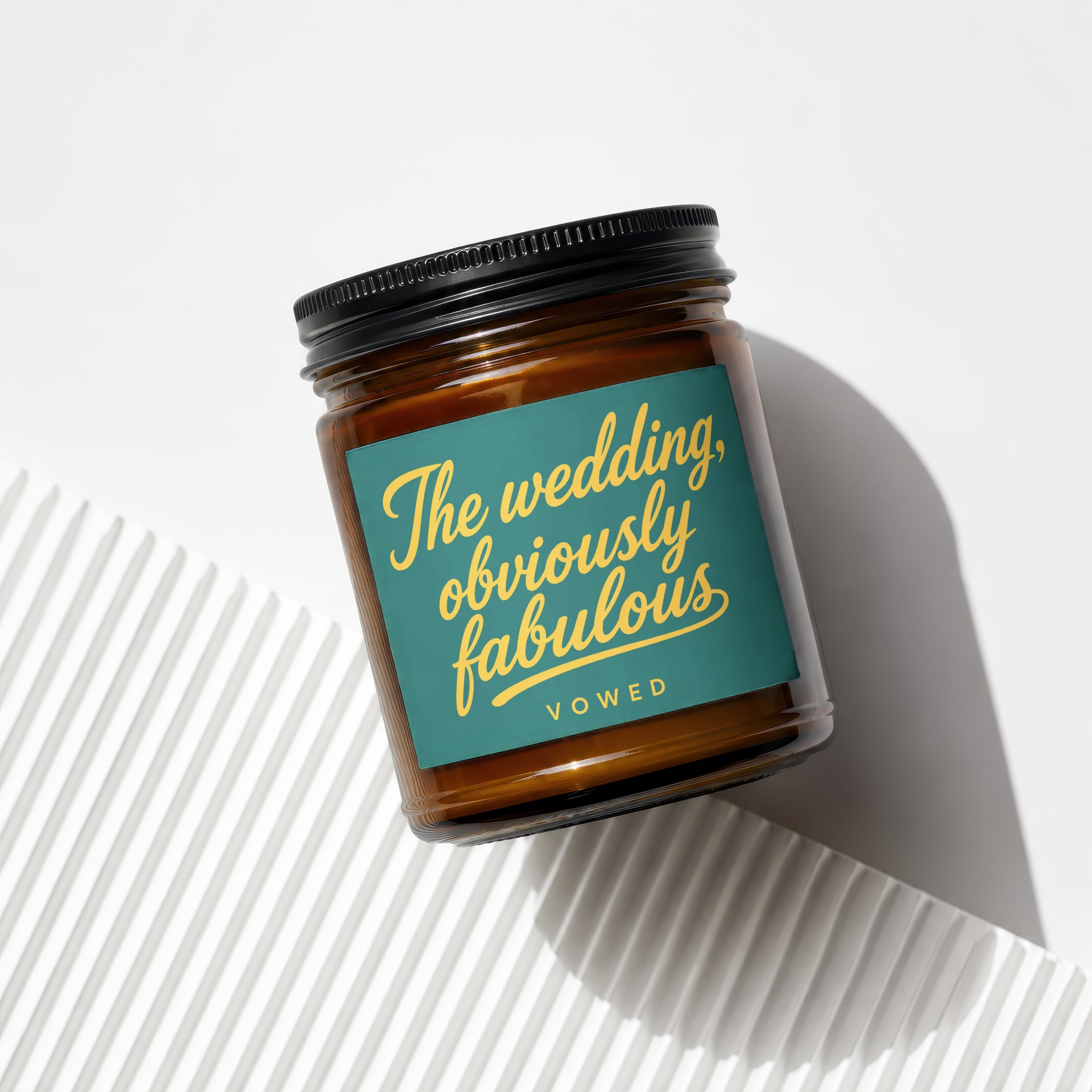 Amber candle in glass jar with label: "The wedding, obviously fabulous"