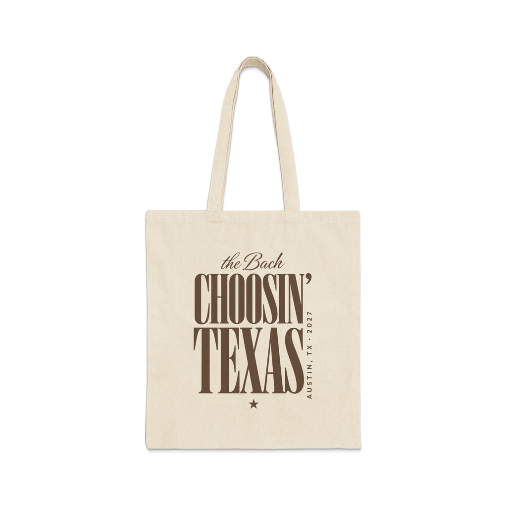 Off-white canvas tote bag featuring brown text that reads the Bach Choosin' Texas Austin, TX 2027.