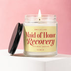 Candle with text "Maid of Honor Recovery" on a yellow label.