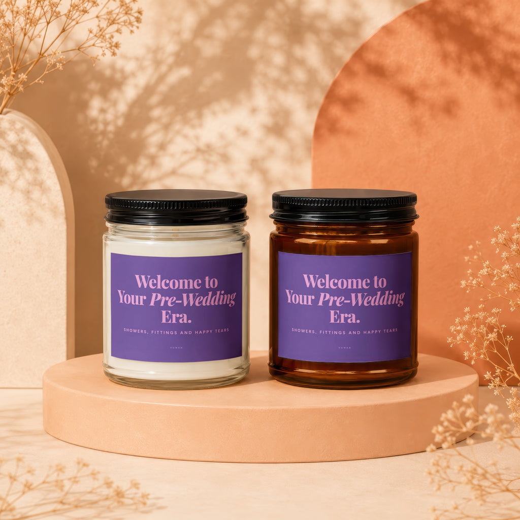 Two candles with purple labels reading "Welcome to Your Pre-Wedding Era."