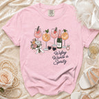 Pink t-shirt with graphic of cocktails, flowers, and text "Wifey Wants a Spritz".
