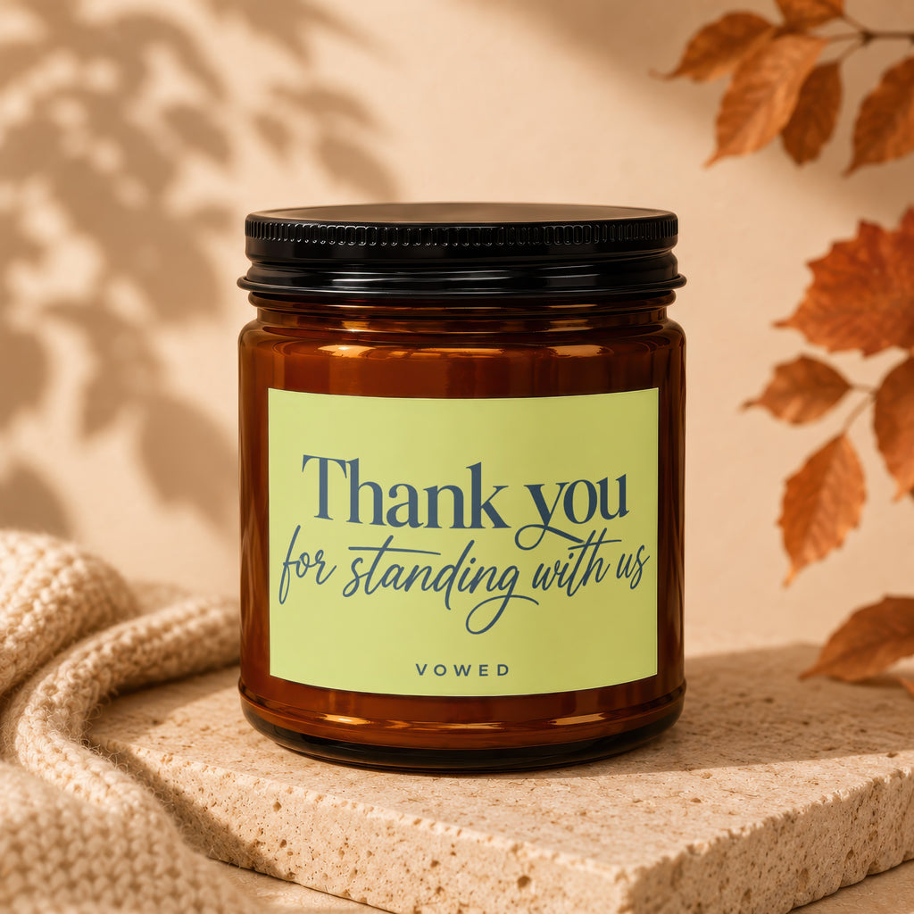Amber candle with black lid, light green label reading "Thank you for standing with us VOWED".