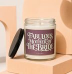 Glass candle labeled "Fabulous Mother of the Bride Vowed" with black lid.