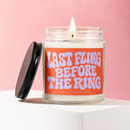 Burning candle with "LAST FLING BEFORE THE RING" text on orange label.
