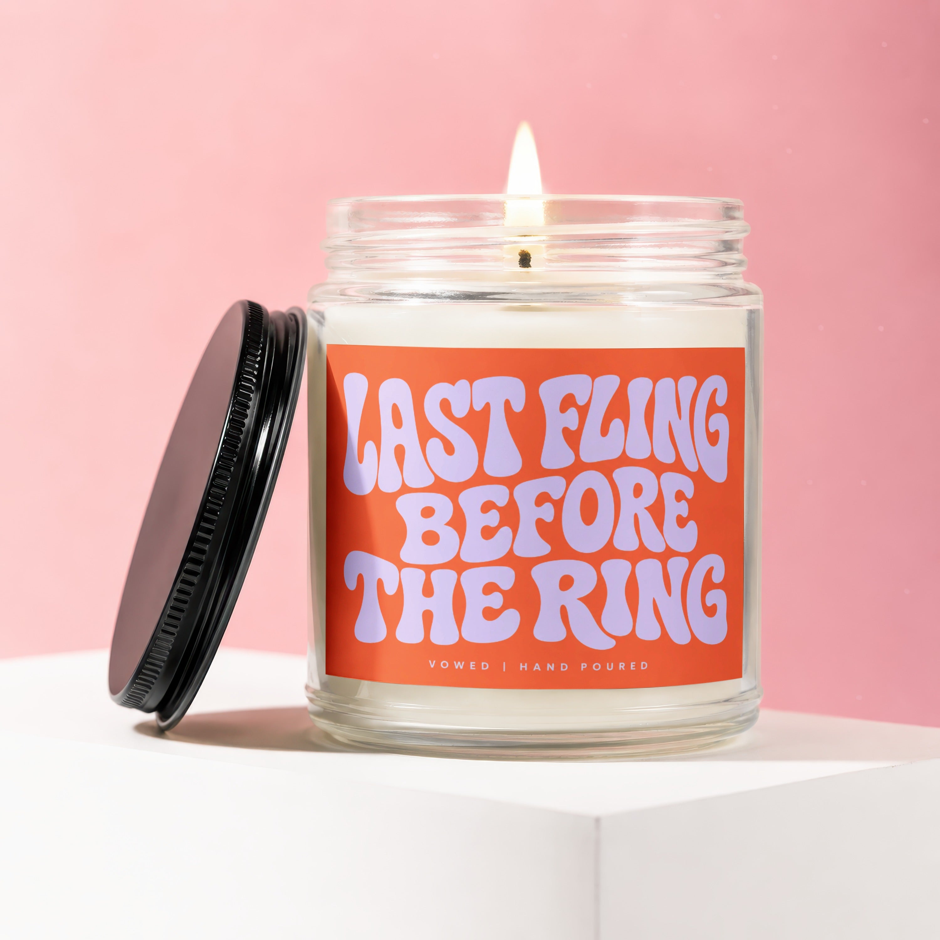 Burning candle with "LAST FLING BEFORE THE RING" text on orange label.