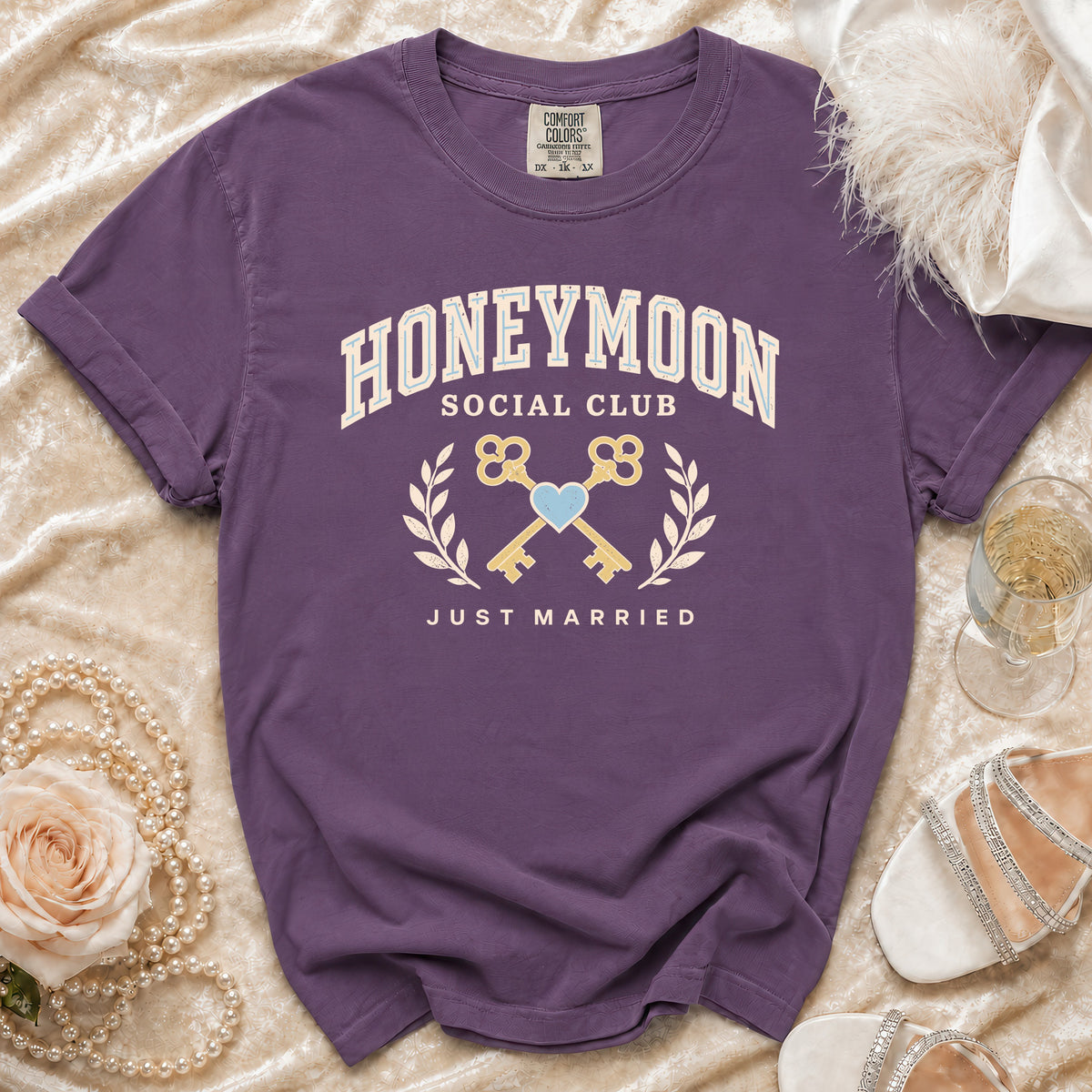 Purple t-shirt with "Honeymoon Social Club Just Married" text and graphic.