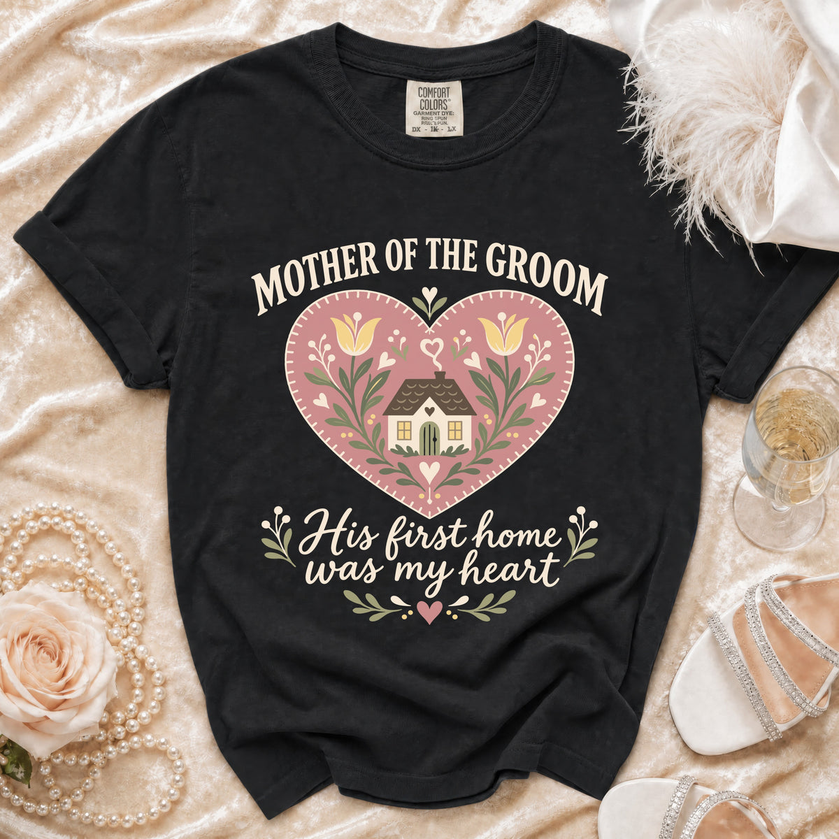 Black t-shirt with "Mother of the Groom His first home was my heart" text and heart graphic.