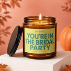 Amber candle with lid removed, reads "Hey Bestie You're In The Bridal Party."