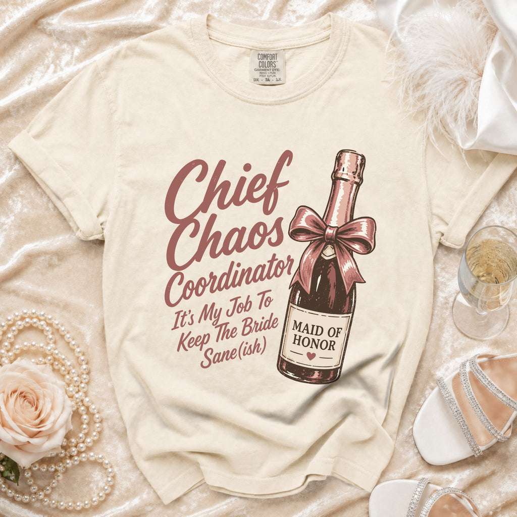 Cream t-shirt with "Chief Chaos Coordinator" and champagne bottle graphic.