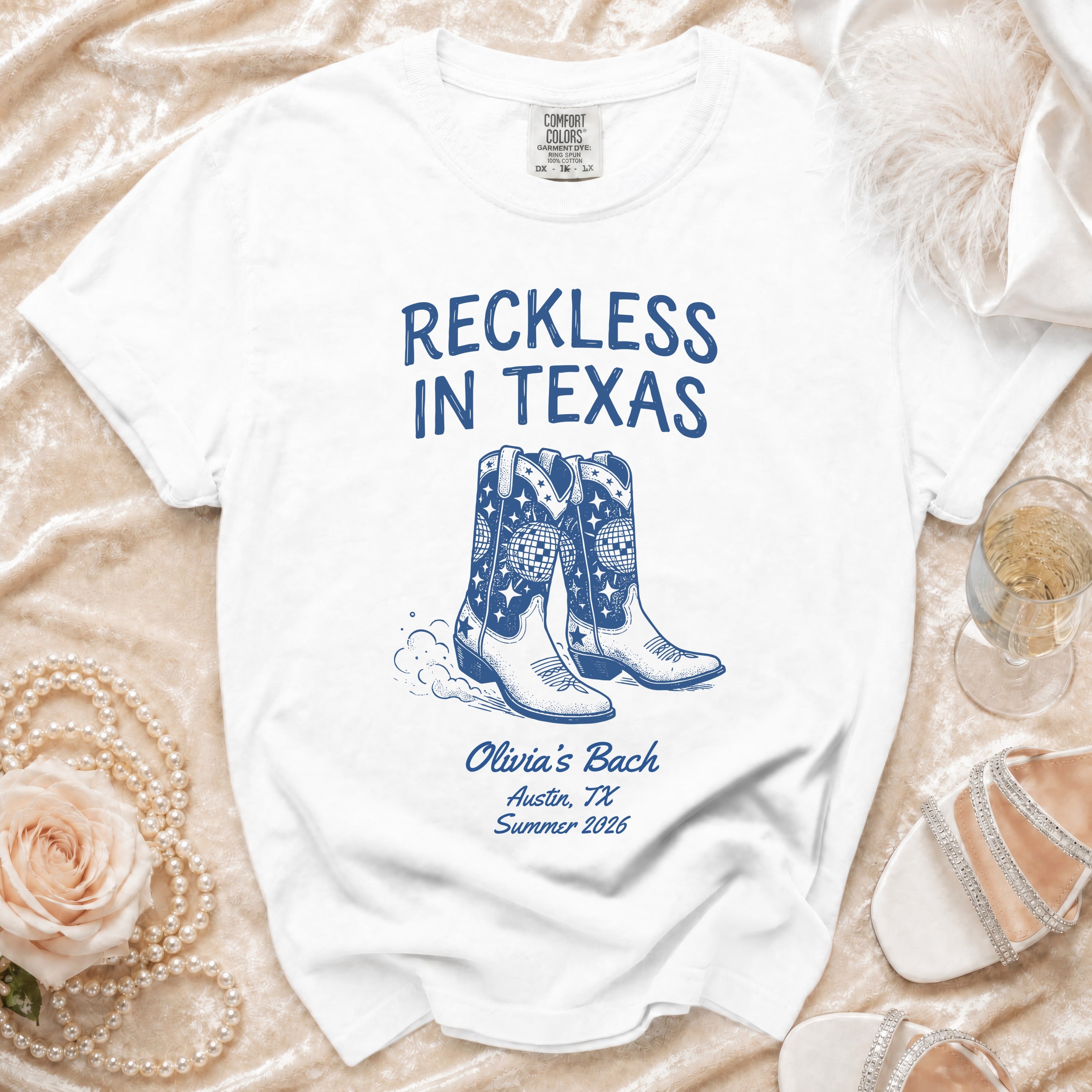 White t-shirt with "Reckless in Texas" and cowboy boots graphic.