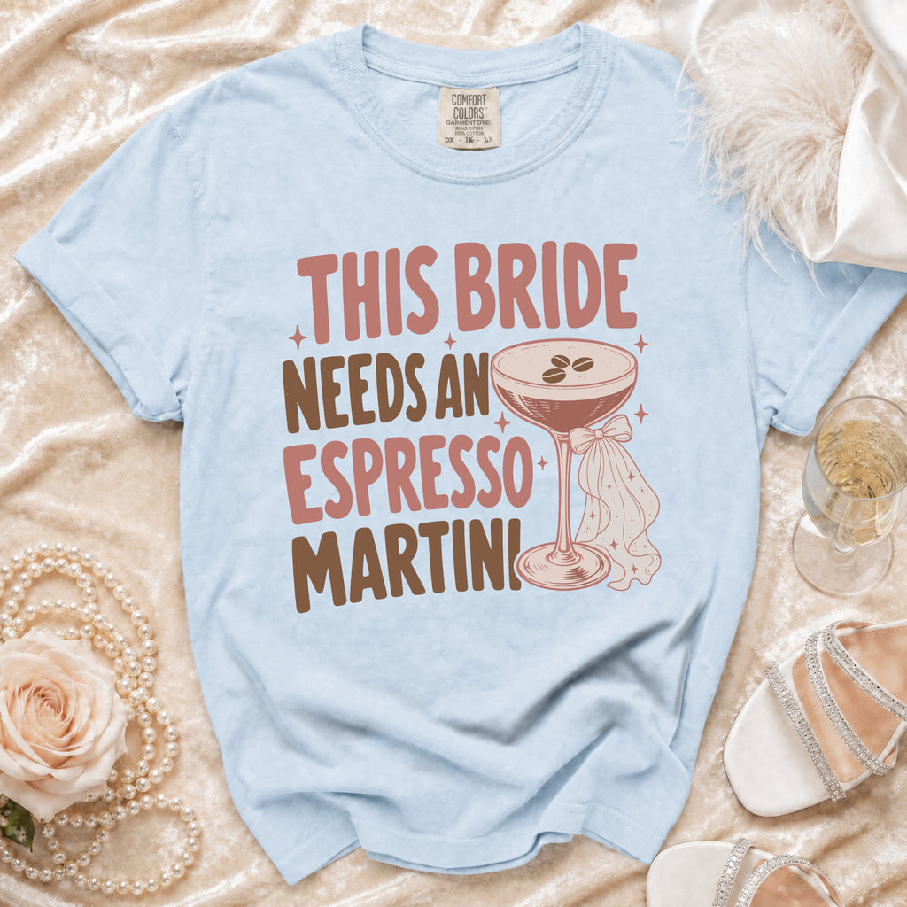 Light blue t-shirt with "This Bride Needs An Espresso Martini" graphic.