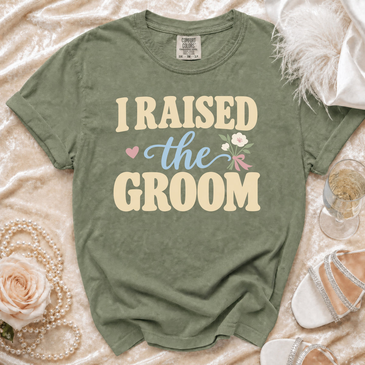 Olive green t-shirt with "I RAISED the GROOM" text and floral graphic.