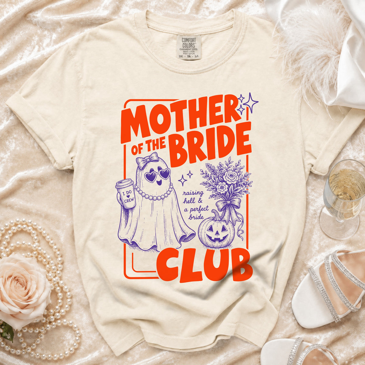 Cream t-shirt with "Mother of the Bride Club" graphic featuring a ghost, pumpkin, and bouquet.