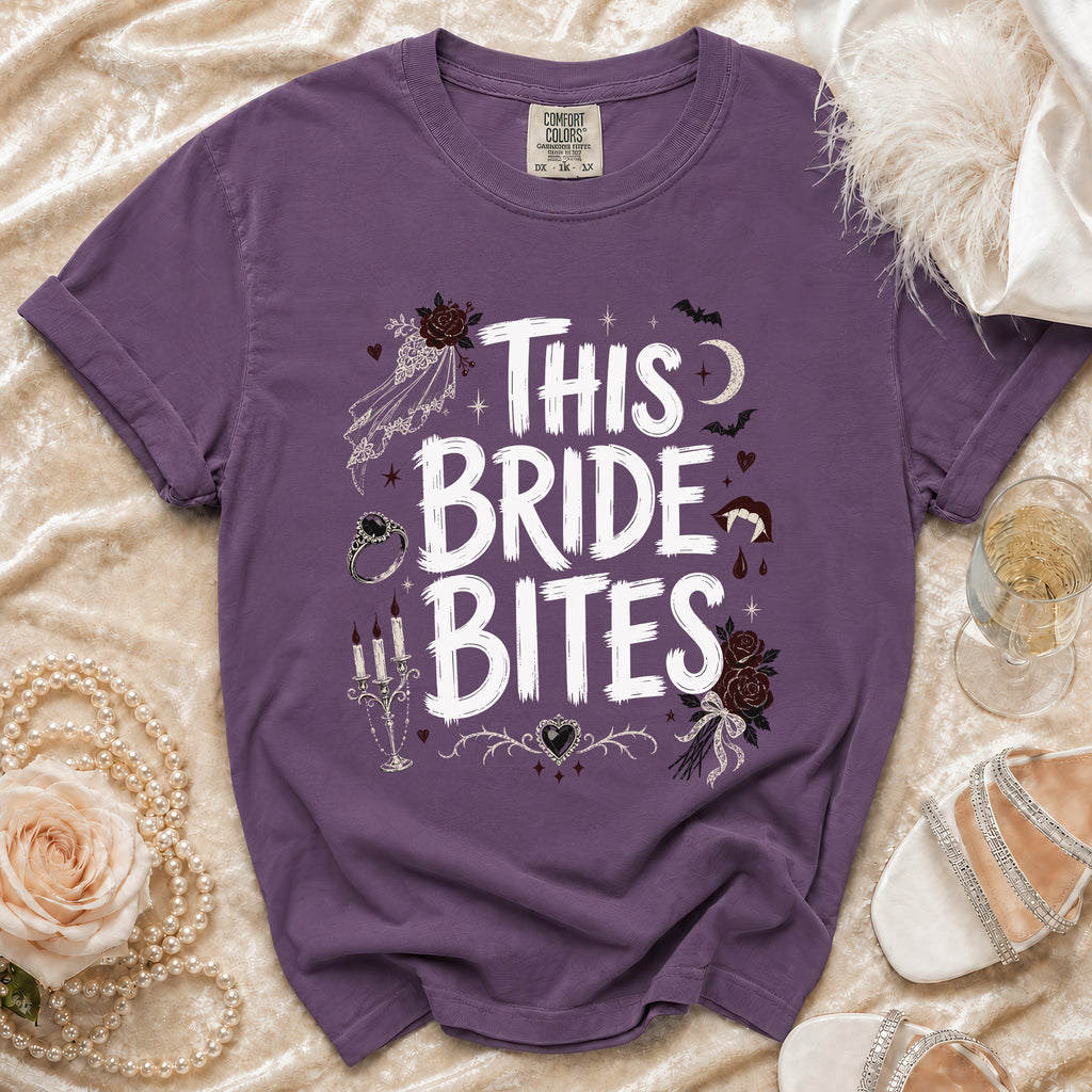 Purple t-shirt with "This Bride Bites" text and gothic wedding graphics.