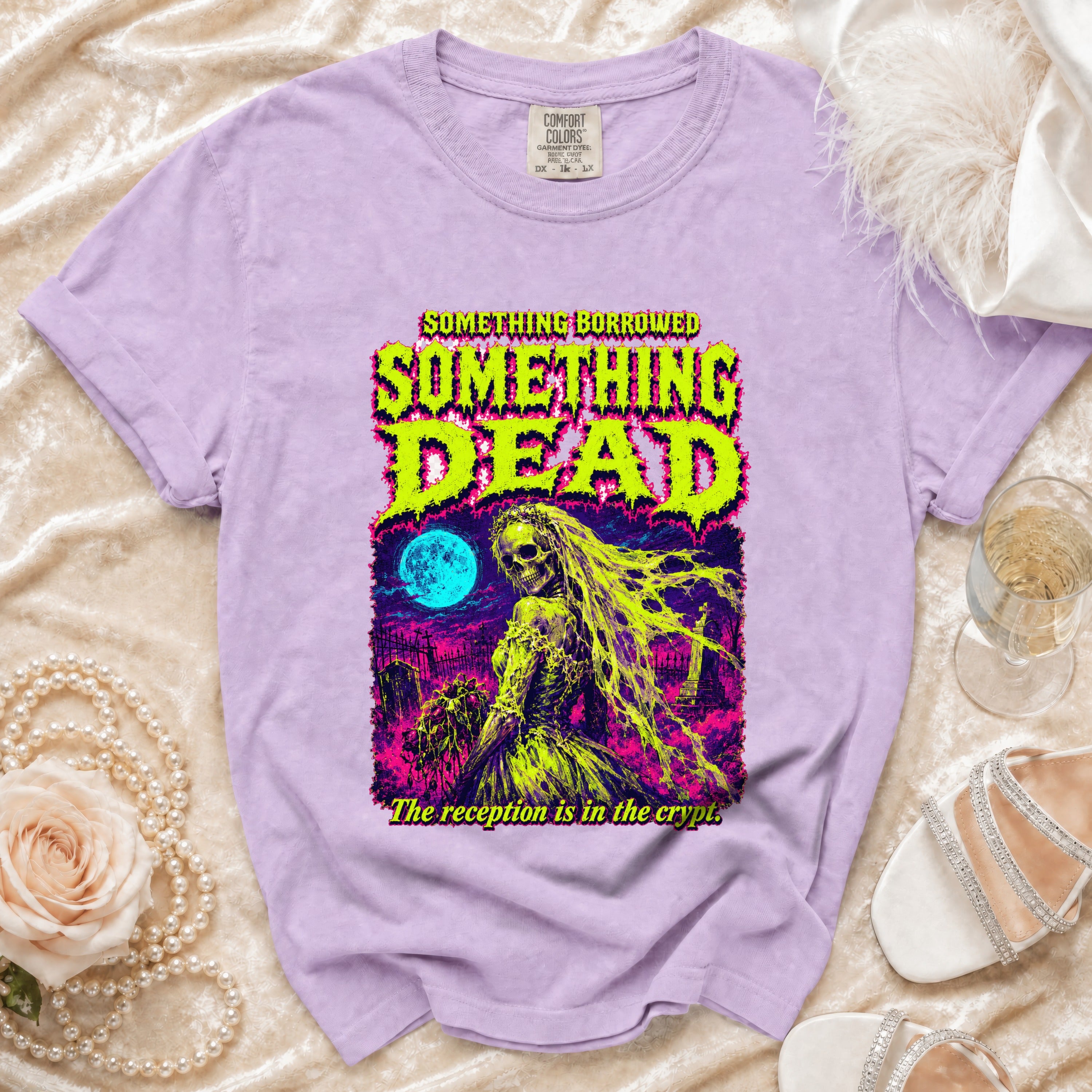 Purple t-shirt with "Something Borrowed Something Dead" skull bride graphic and crypt text.