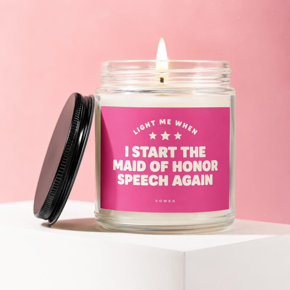 Glass jar candle with pink label reading "Light me when I start the maid of honor speech again".