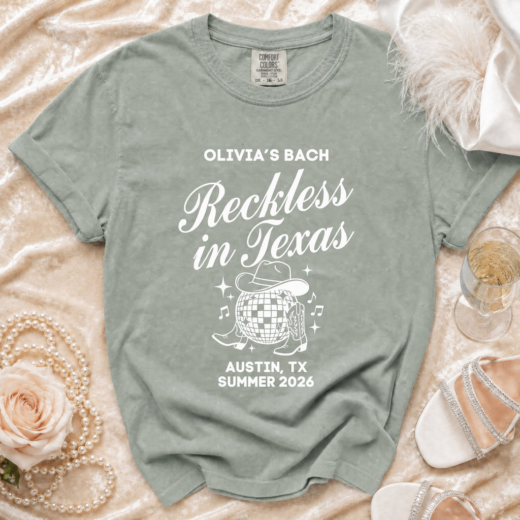Green t-shirt with "Olivia's Bach Reckless in Texas Austin, TX Summer 2026" design.