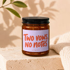 Brown glass candle with a label reading "Two vows, NO notes" and "VOWED".