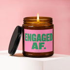 Amber candle with lit flame on pink background, "ENGAGED AF." prominently displayed.