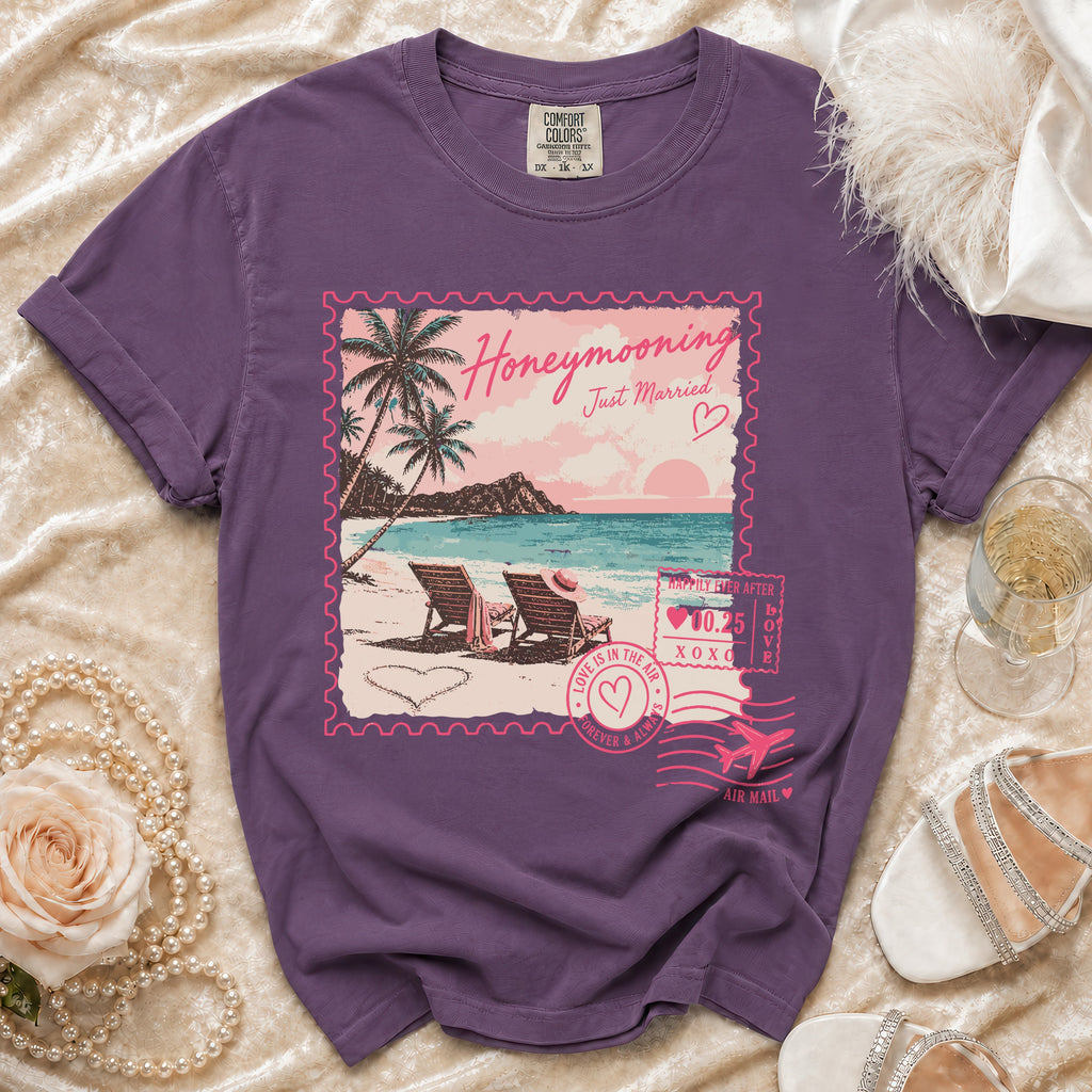 Purple t-shirt with "Honeymooning Just Married" in stamp design.