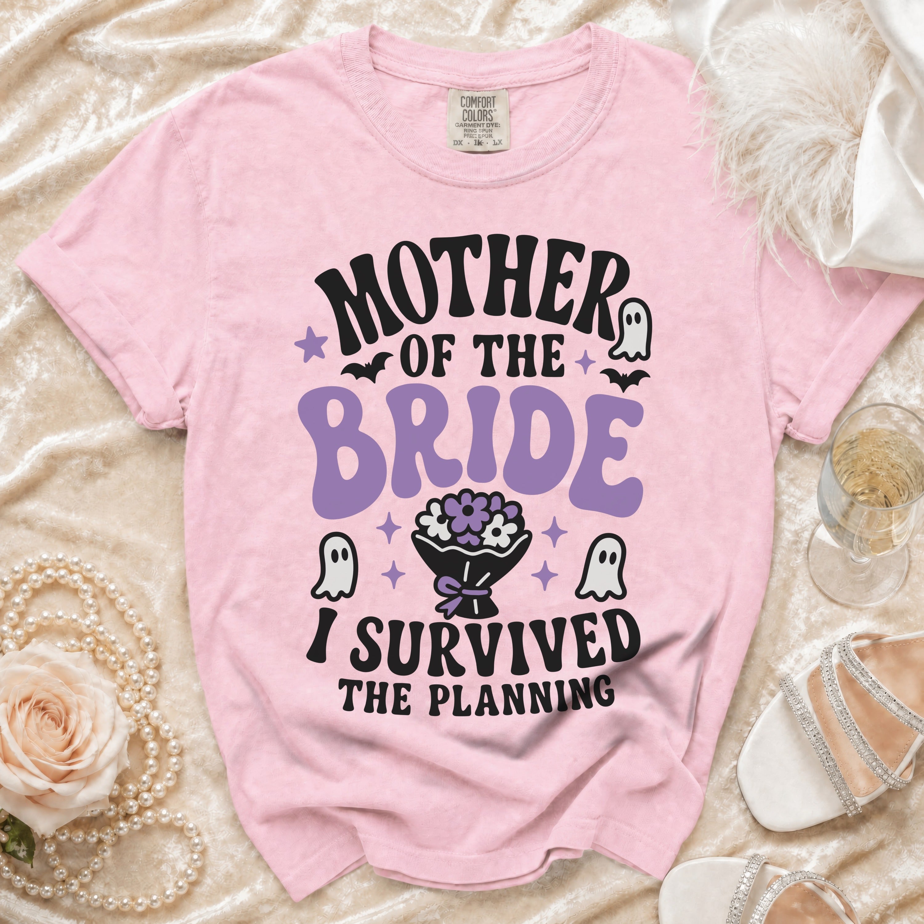 Pink t-shirt with "Mother of the Bride I Survived The Planning" text and ghost graphics.