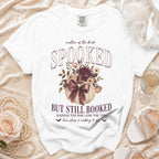 White t-shirt with "mother of the bride SPOOKED BUT STILL BOOKED" Halloween wedding graphic.