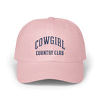 Light pink baseball cap embroidered with dark blue text reading COWGIRL COUNTRY CLUB.