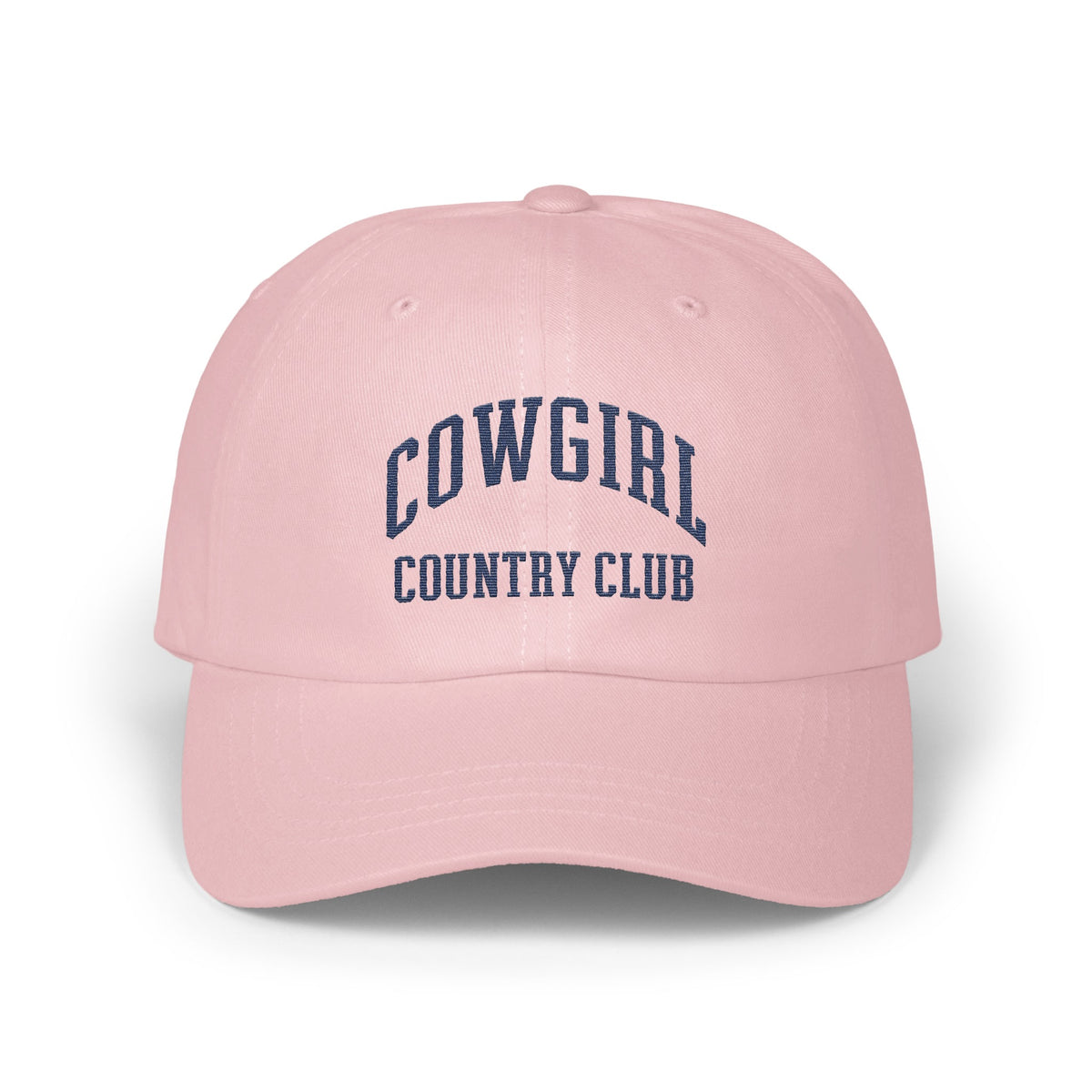 Light pink baseball cap embroidered with dark blue text reading COWGIRL COUNTRY CLUB.