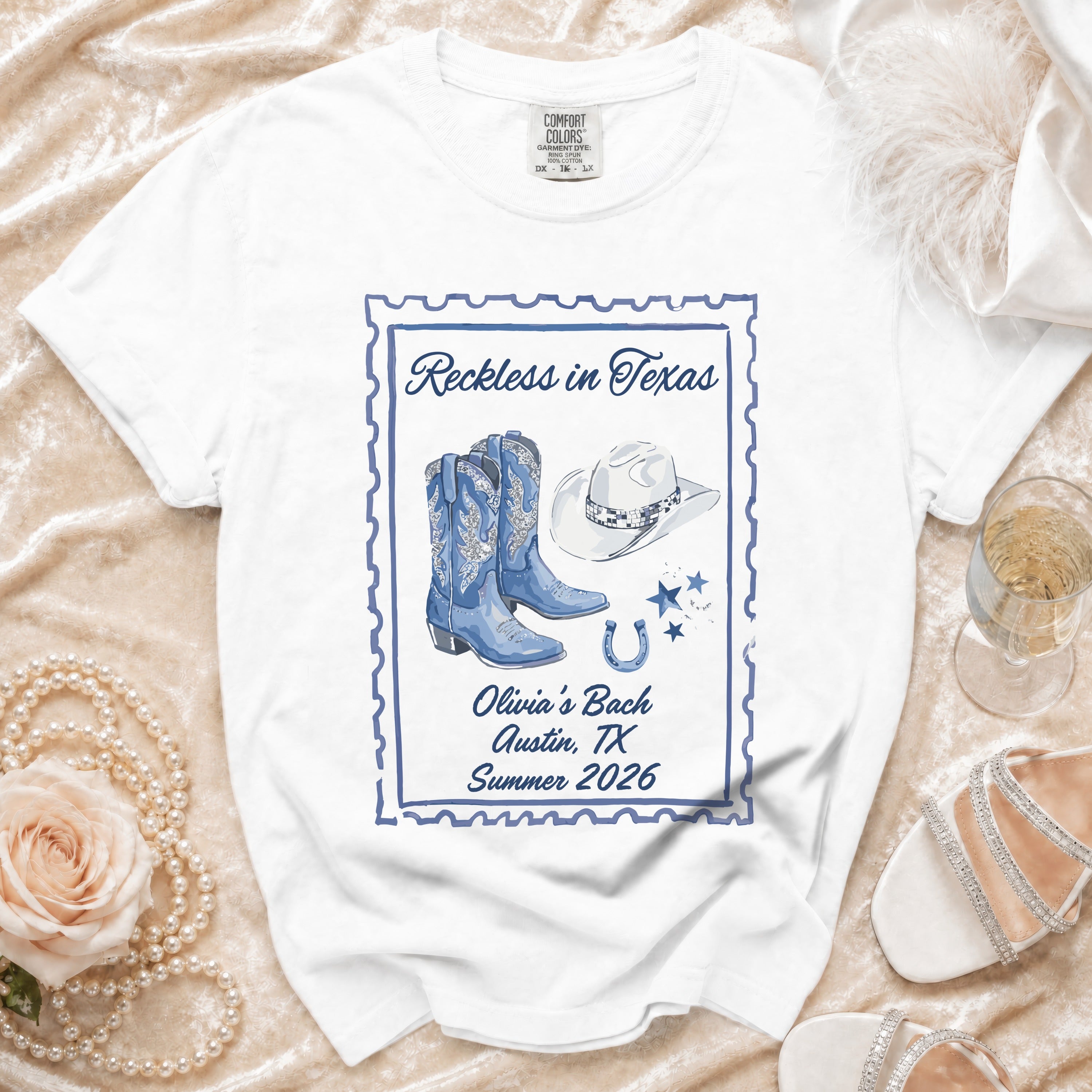 White t-shirt with "Reckless in Texas" and cowgirl boot graphic.