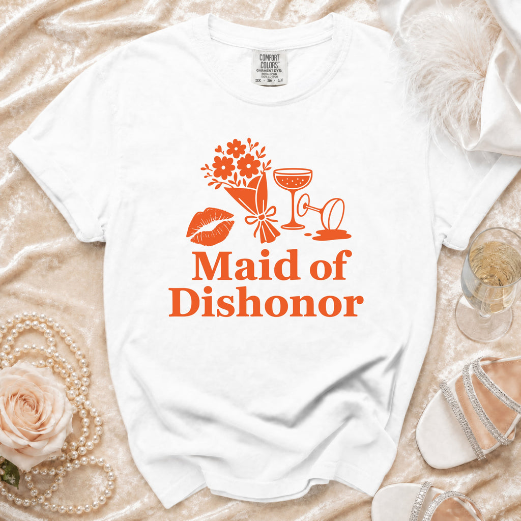White t-shirt with orange graphic: "Maid of Dishonor," lipstick, flowers, and cocktail glasses.