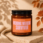 Amber candle with black lid inscribed "WEDDING WEEKEND SURVIVOR" and "VOWED".