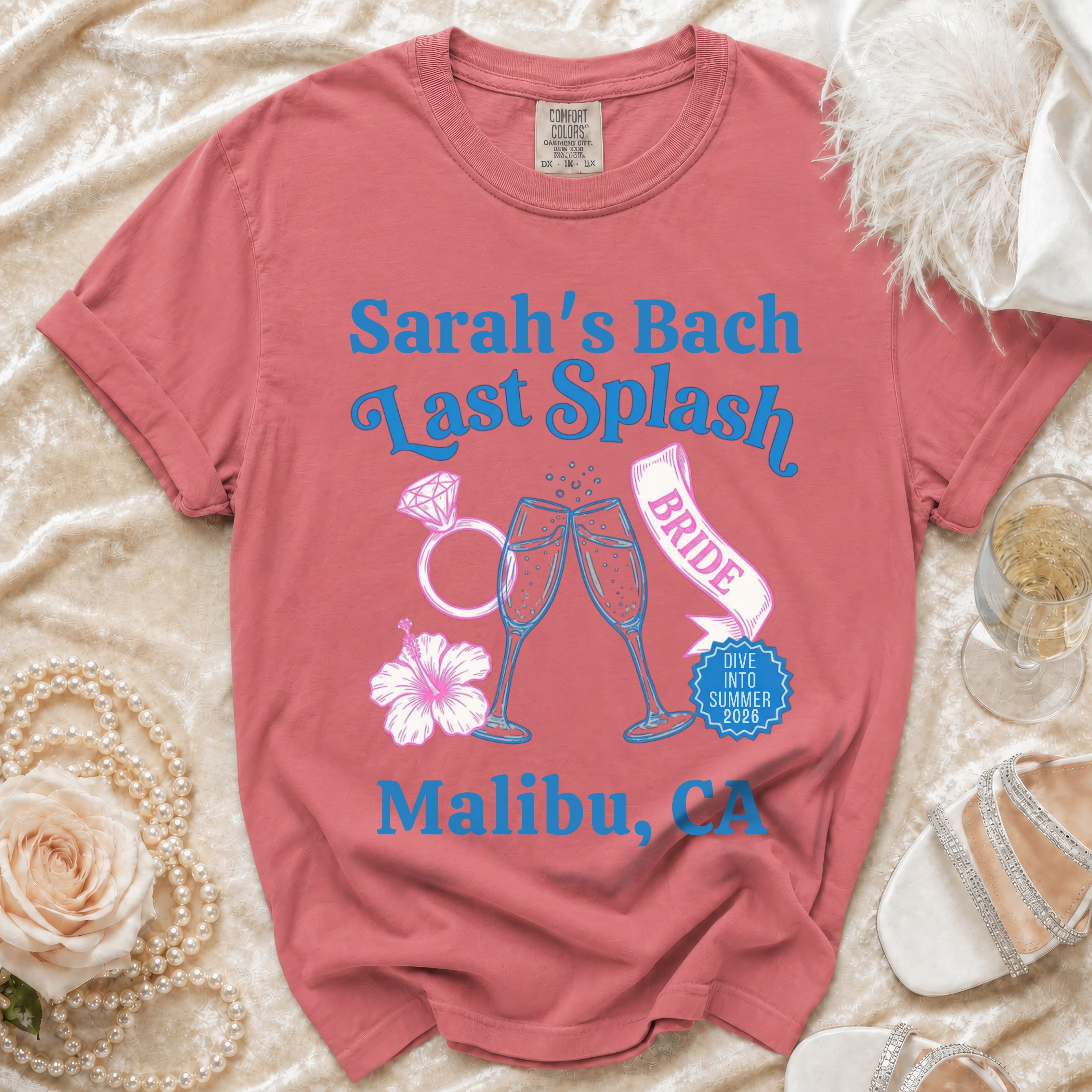 Pink t-shirt with "Sarah's Bach Last Splash Bride" text, champagne glasses, ring, and flower.