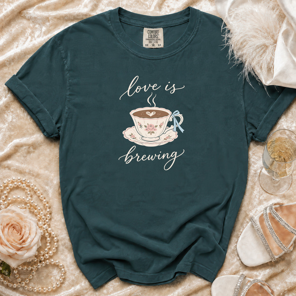 Teal t-shirt with "love is brewing" and a teacup graphic.