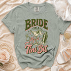 T-shirt with "Bride in a Tini Bit" text, martini, ring, and shaker graphic.