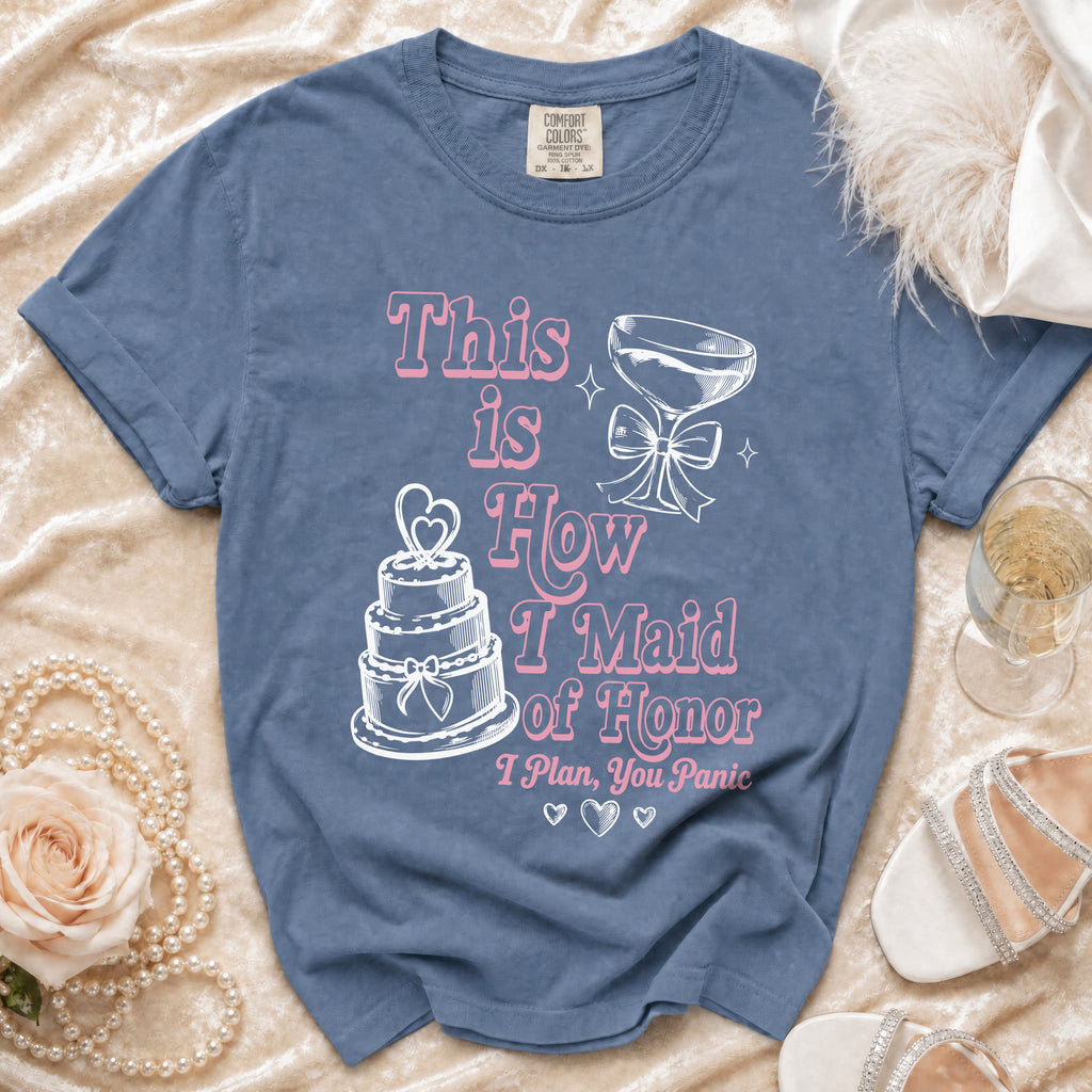 Blue t-shirt with "This is How I Maid of Honor I Plan, You Panic" text and graphics.